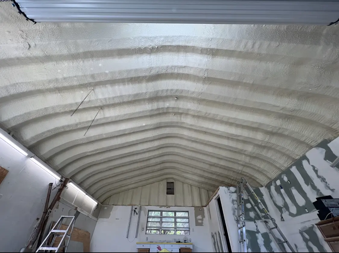 Spray polyurethane foam applied to the underside of a metal roof deck in Houma